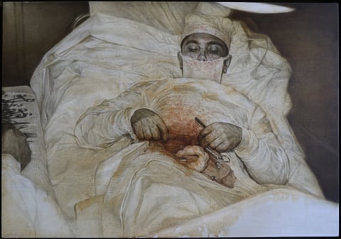 A figure lying under pale bedcovers, with hands meeting at the chest.